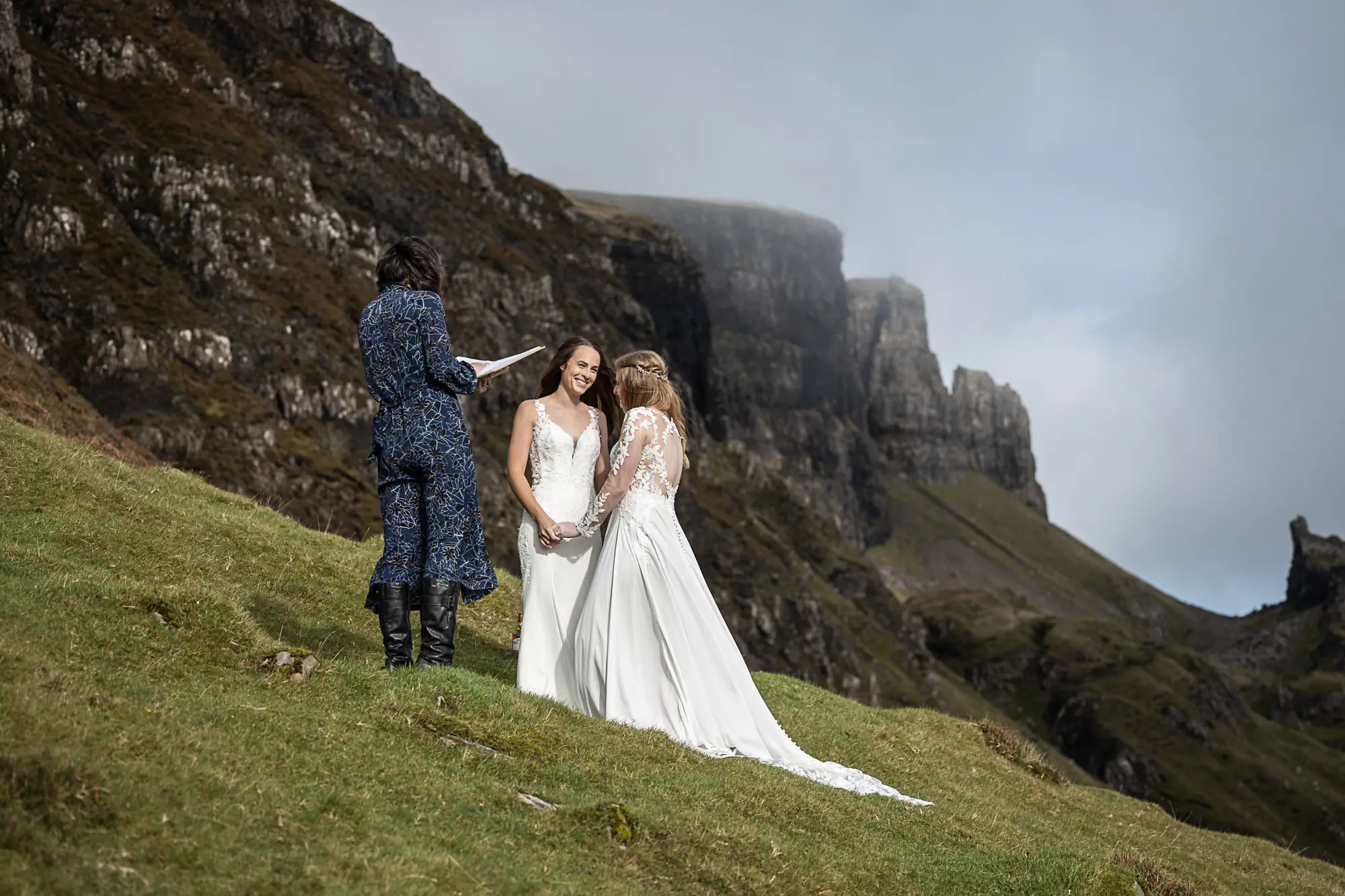 two ladies in white dresses exchange vows