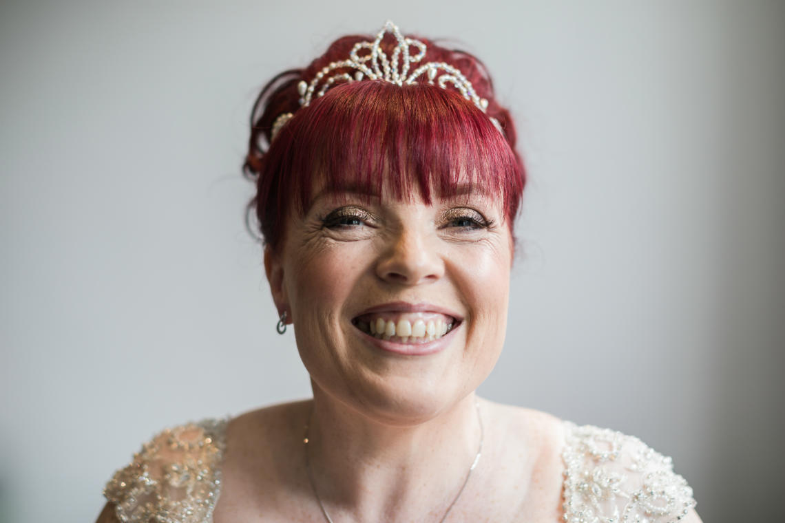 bride smiling at the camera pre-ceremony