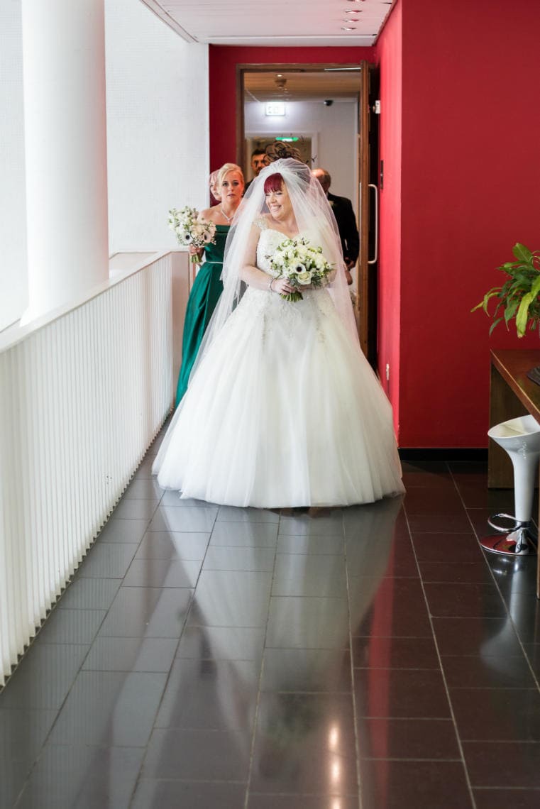 smiling bride makes her way to the ceremony