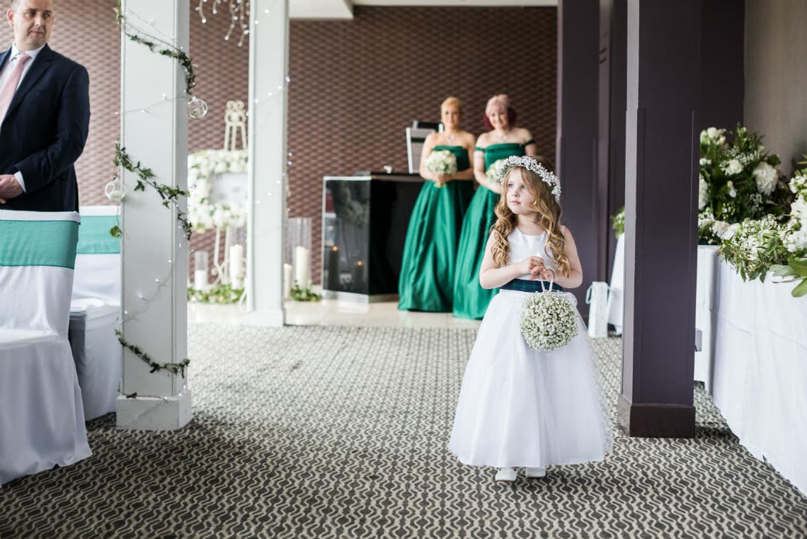 flower girl walks up the aisle