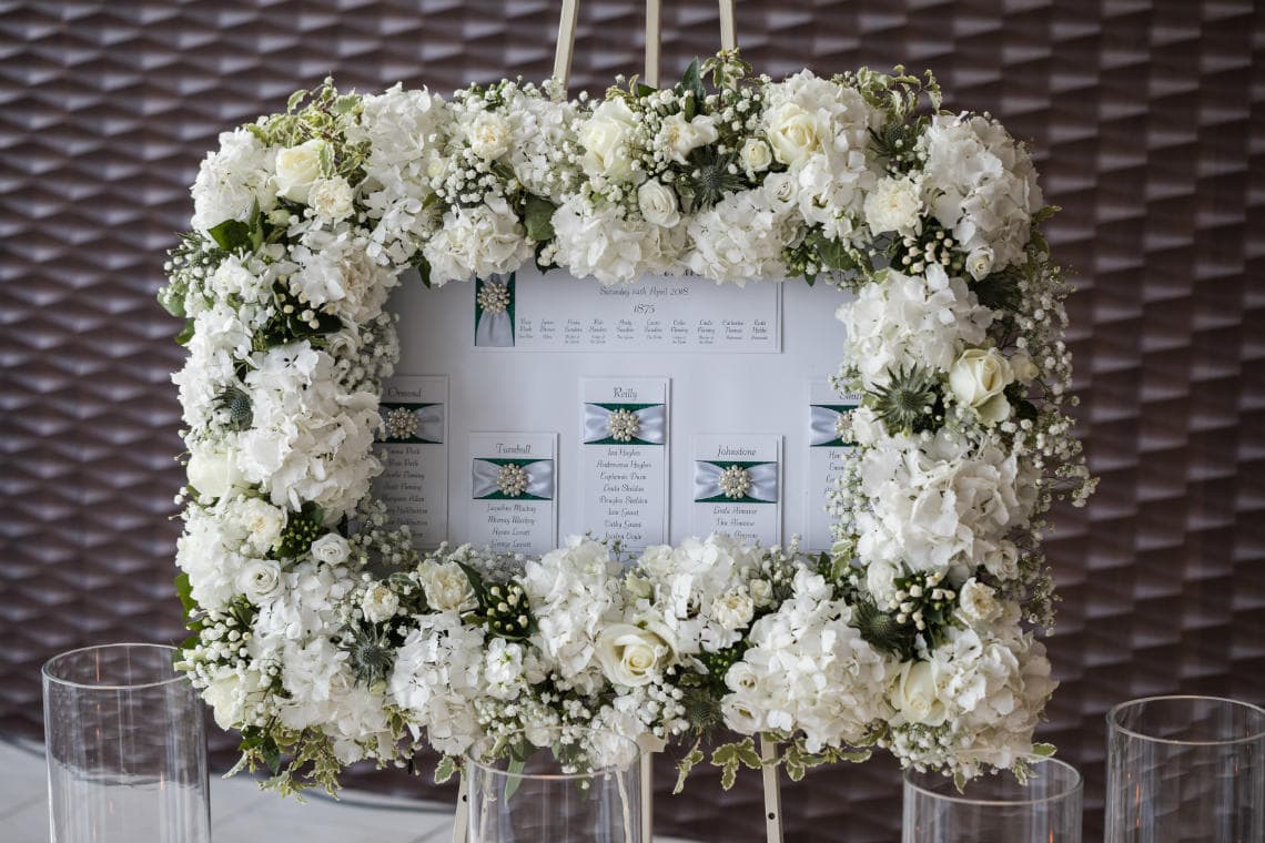 table seating plan framed by white flowers