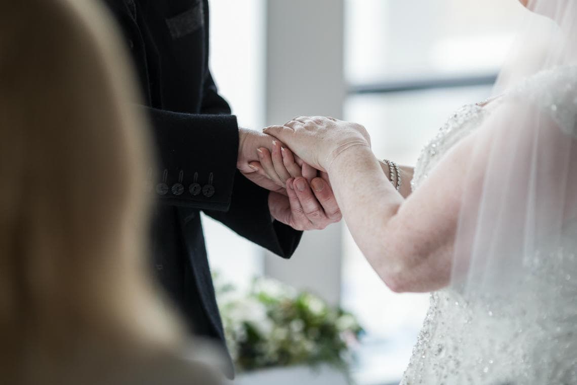 bride and groom holding hands during the exchange of vows during Humanist ceremony in the Heights Restaurant