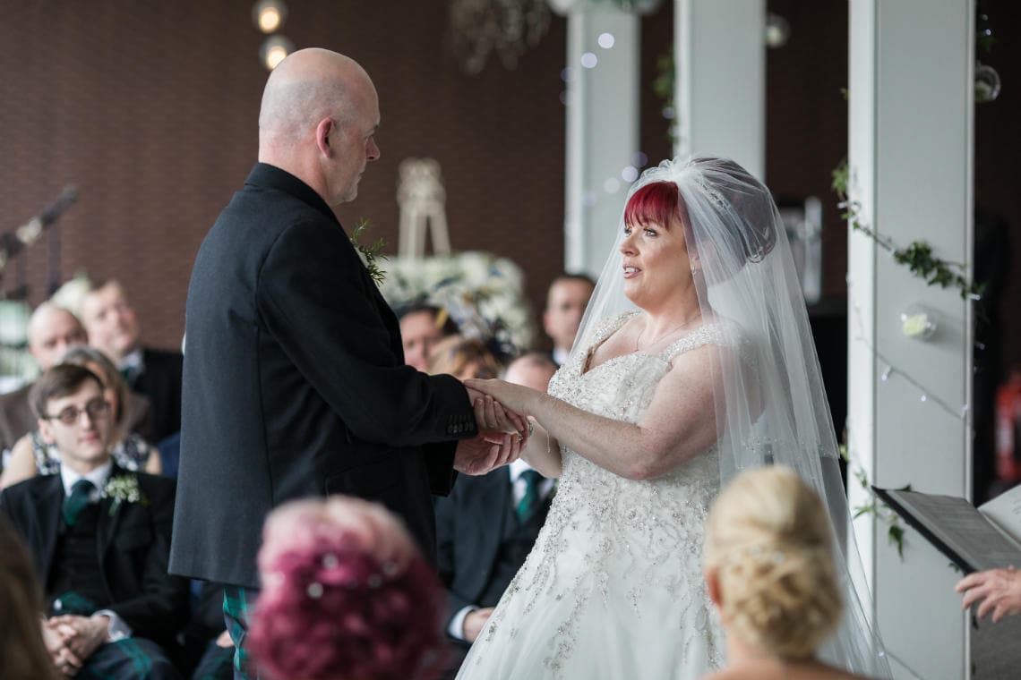 bride and groom holding hands during the exchange of vows during Humanist ceremony in the Heights Restaurant