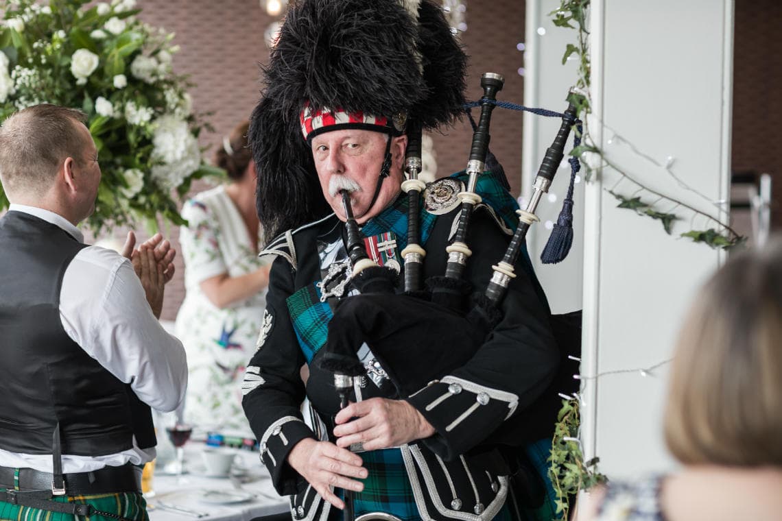 piper escorts newlyweds to the top table