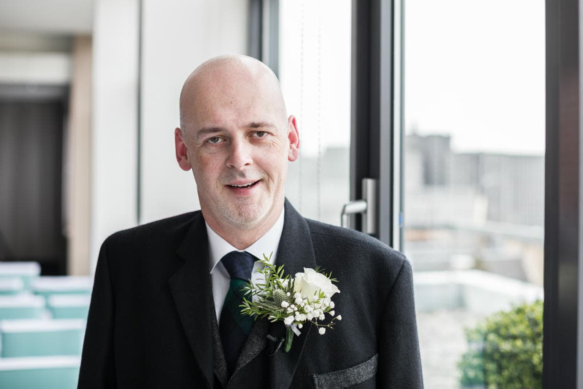 groom standing in the Heights restaurant