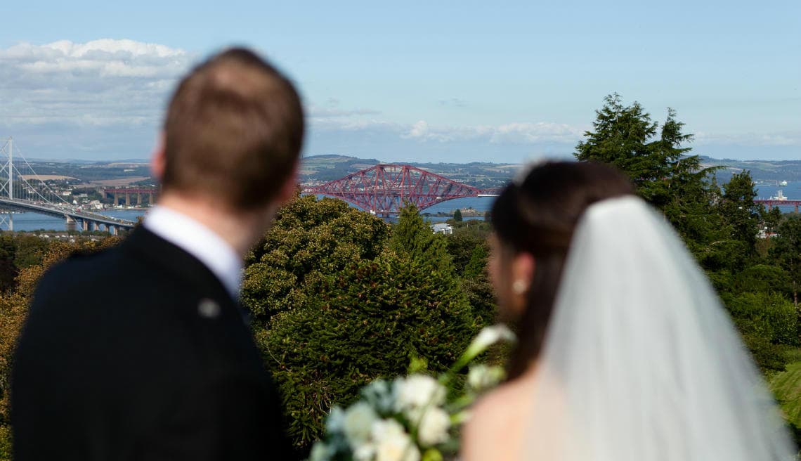Auld Keep Great Hall rooftop newlyweds looking at the Forth Bridges