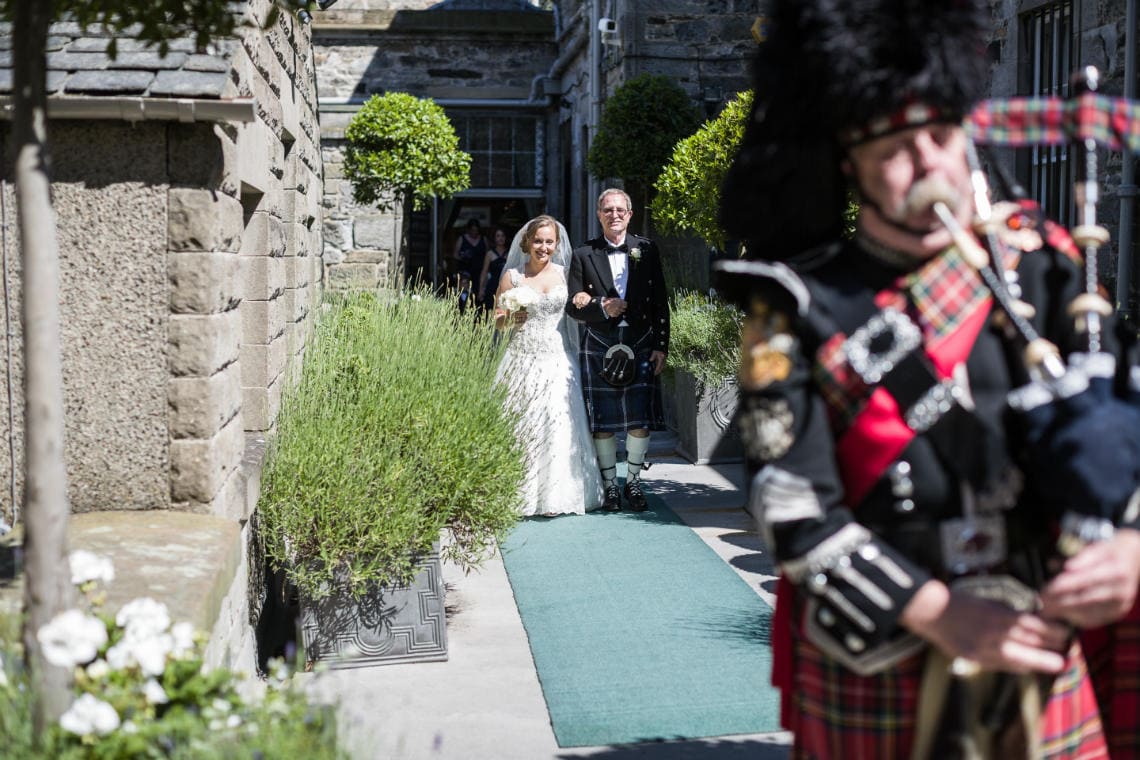 Auld Keep processional piper leads the bridal party