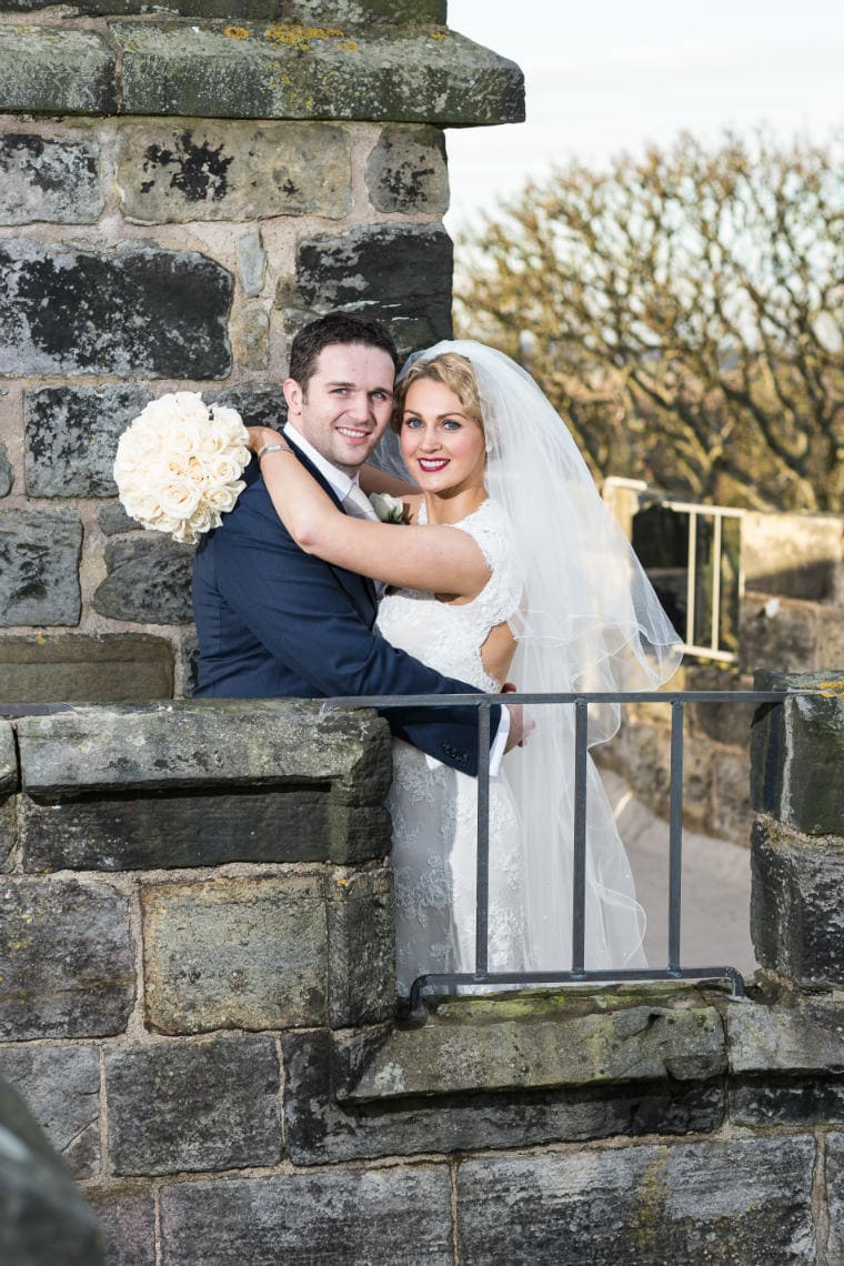 Auld Keep rooftop newlyweds embrace cheek to cheek