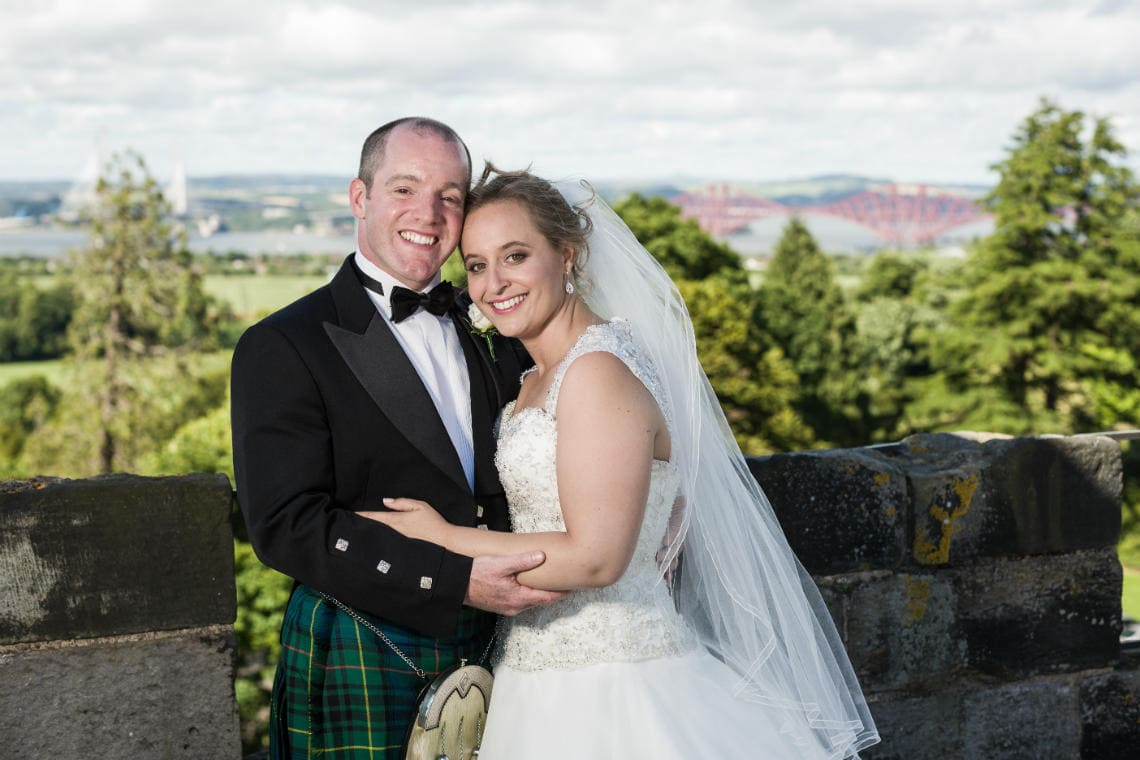 Auld Keep rooftop newlyweds embracing