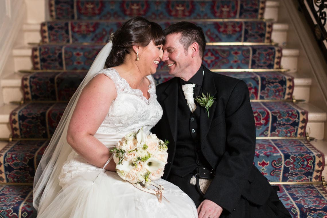 newlyweds sitting on the grand staircase