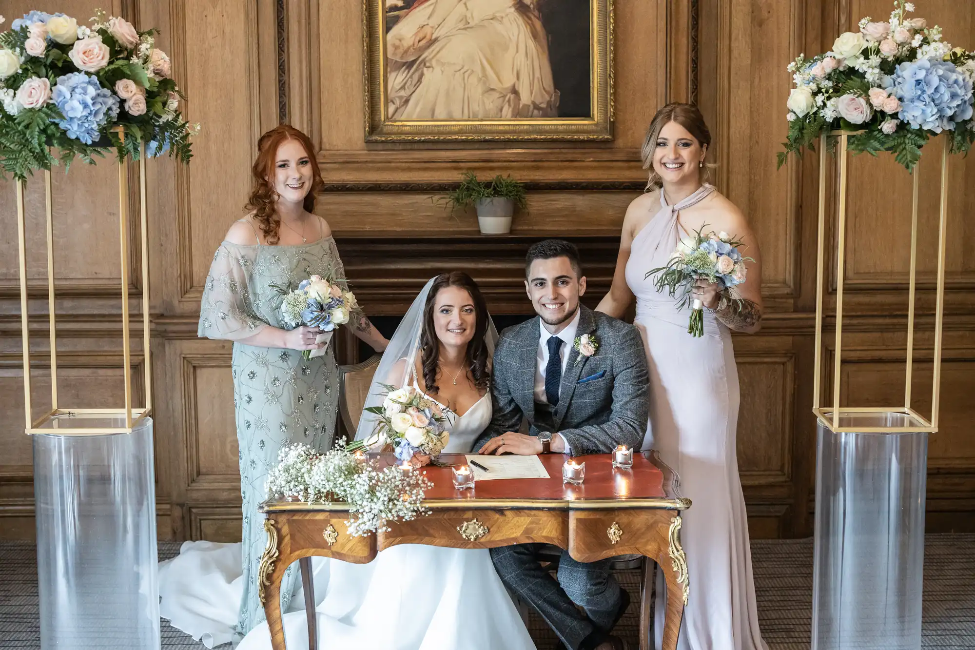 newlyweds and bridesmaids smiling at the camera