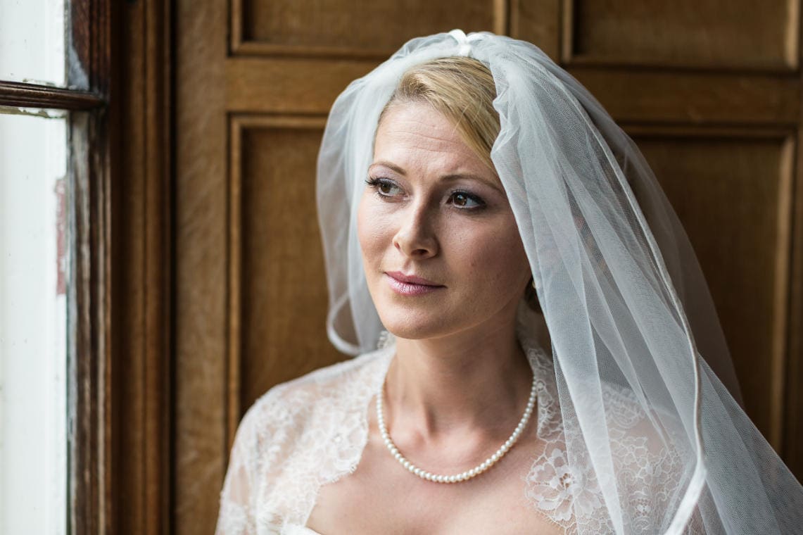 bride looking out the window of the Library