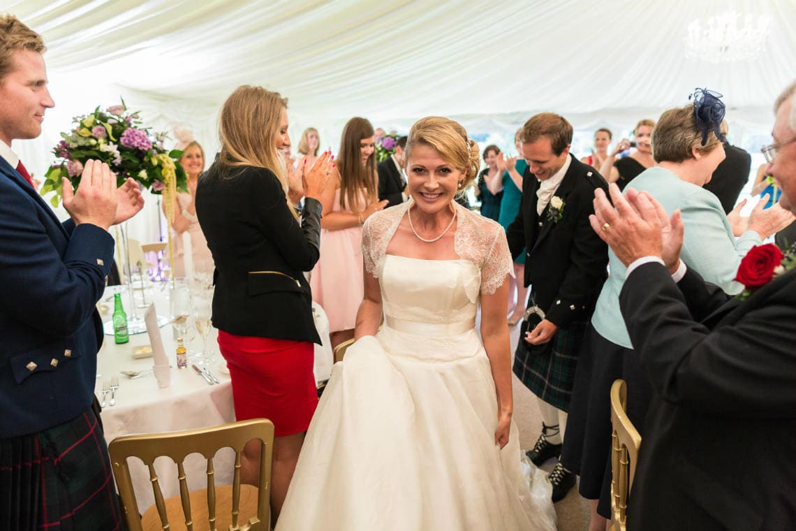 the newlyweds make their way to the top table in The Pavilion