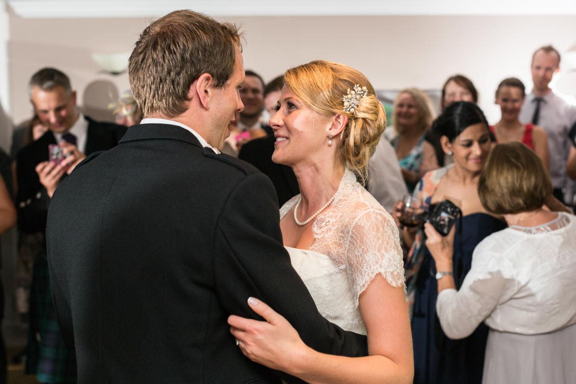 Newlyweds' smiling at each other during their first dance in the Rose Garden Room