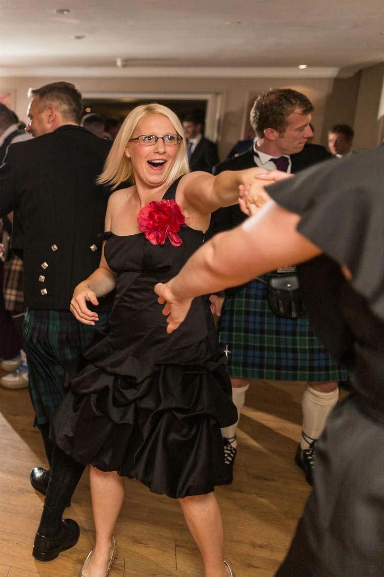 blonde haired female guest dancing newlyweds' first dance in the Rose Garden Room