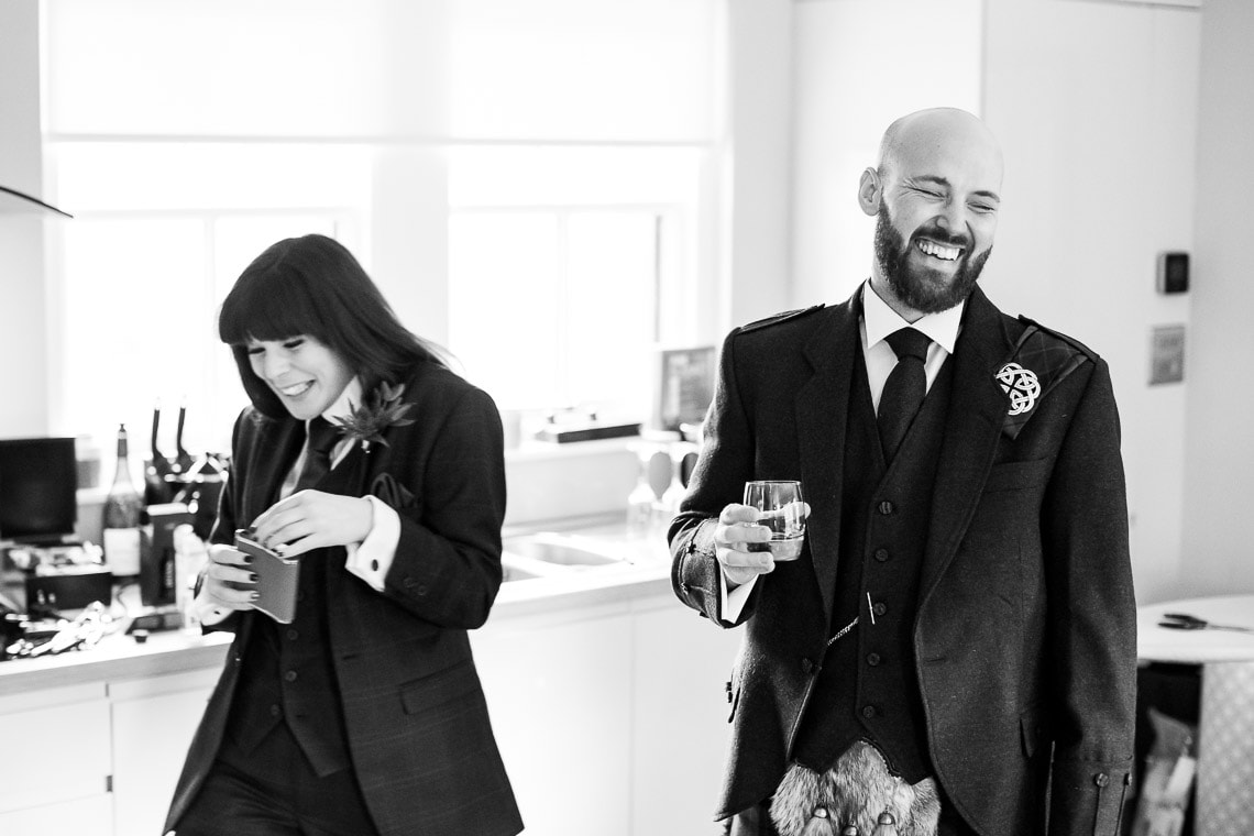 groom and best friends laughing before the ceremony