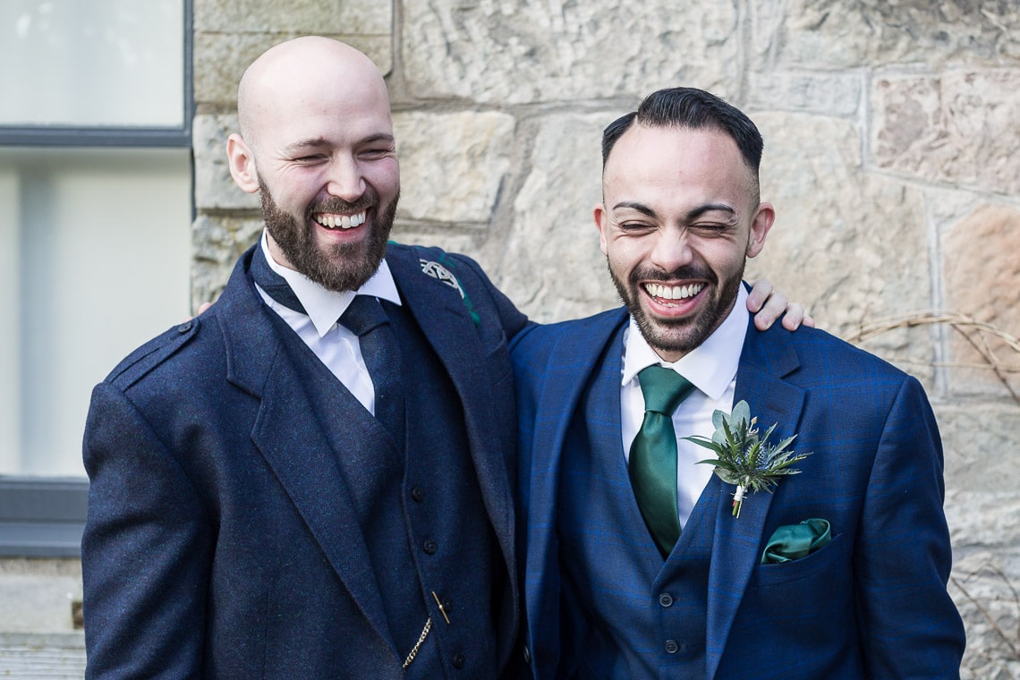 groom and best man laughing