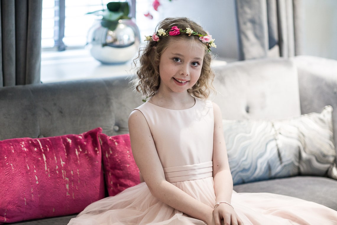 flower girl sitting posing pre-ceremony