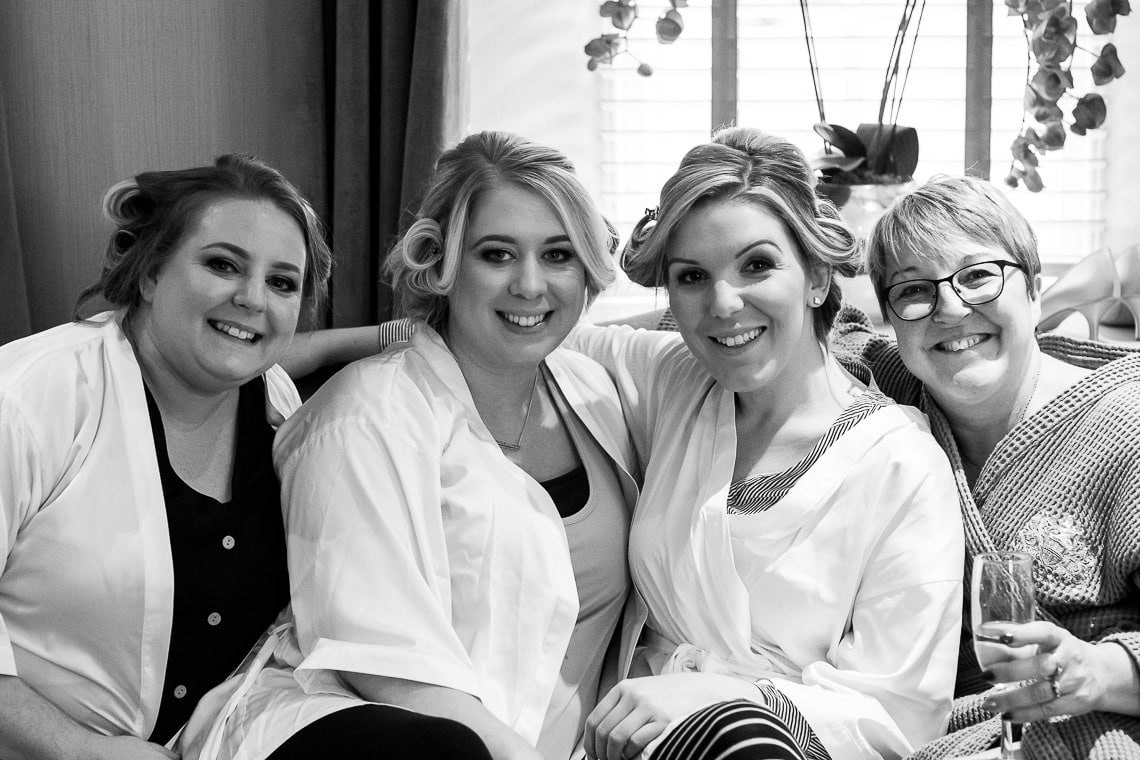 bridesmaids smiling for a photo pre-ceremony
