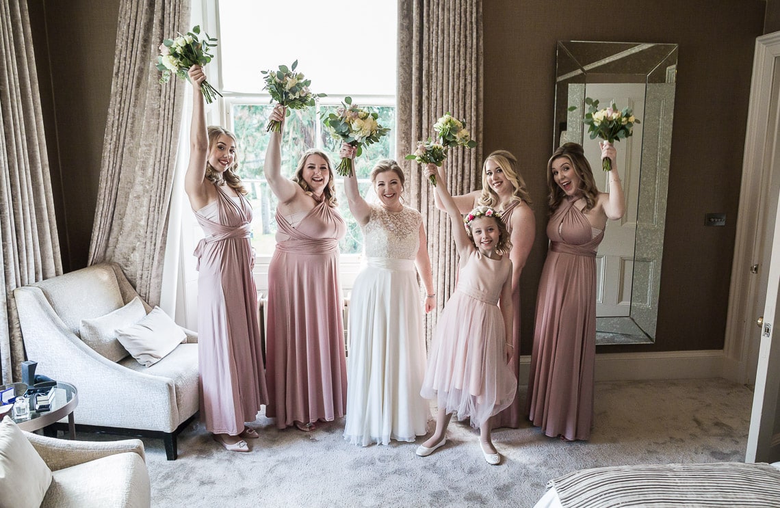 bride, bridesmaids and flower girl pre-ceremony group photo in bedroom