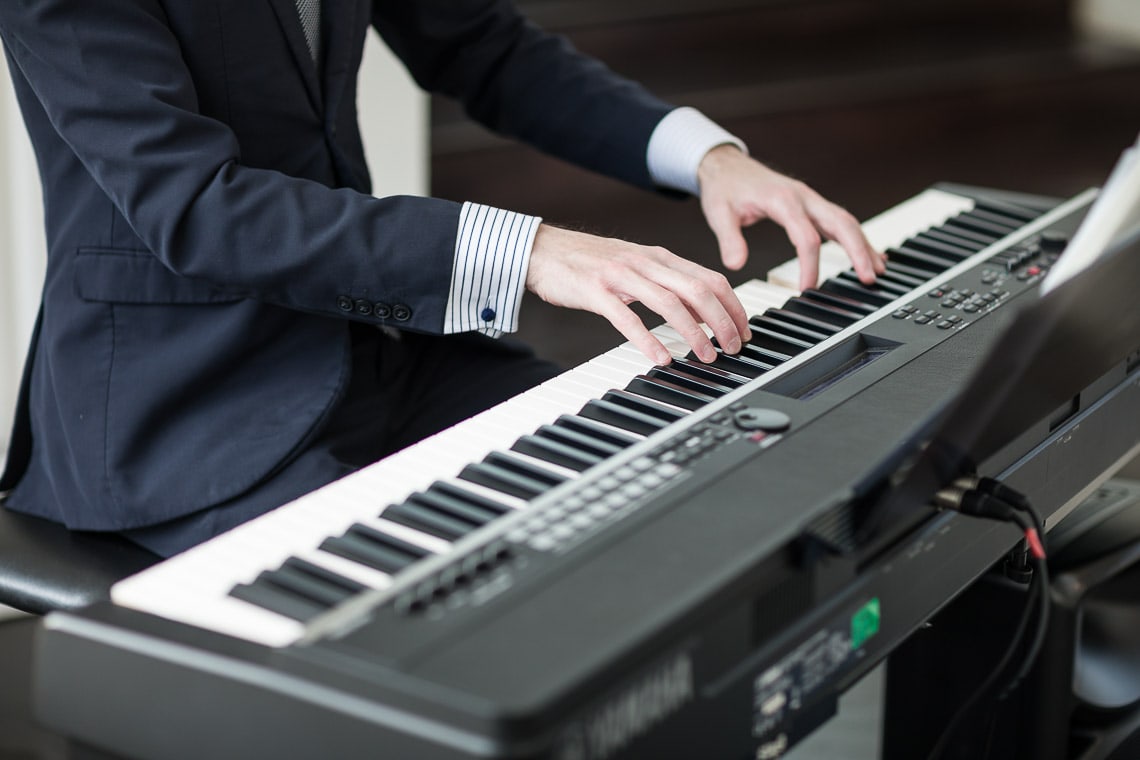 piano player in the Orangery close up of hands playing
