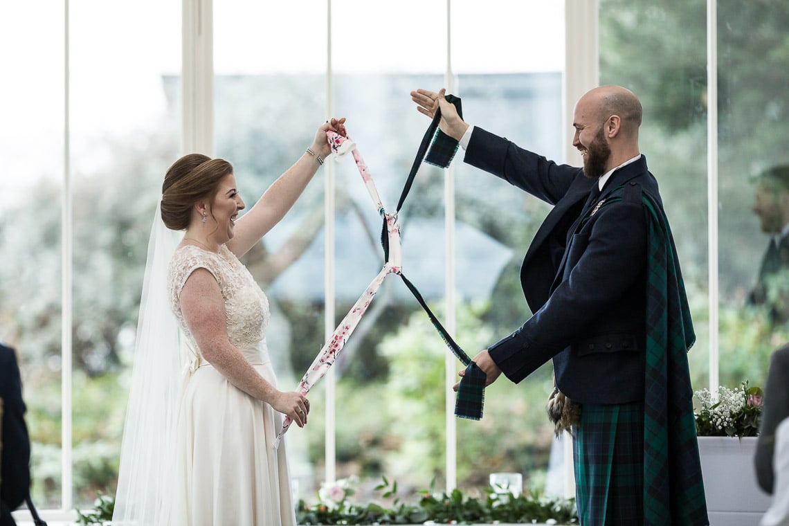 bride and groom tying the knot ceremony in The Orangery