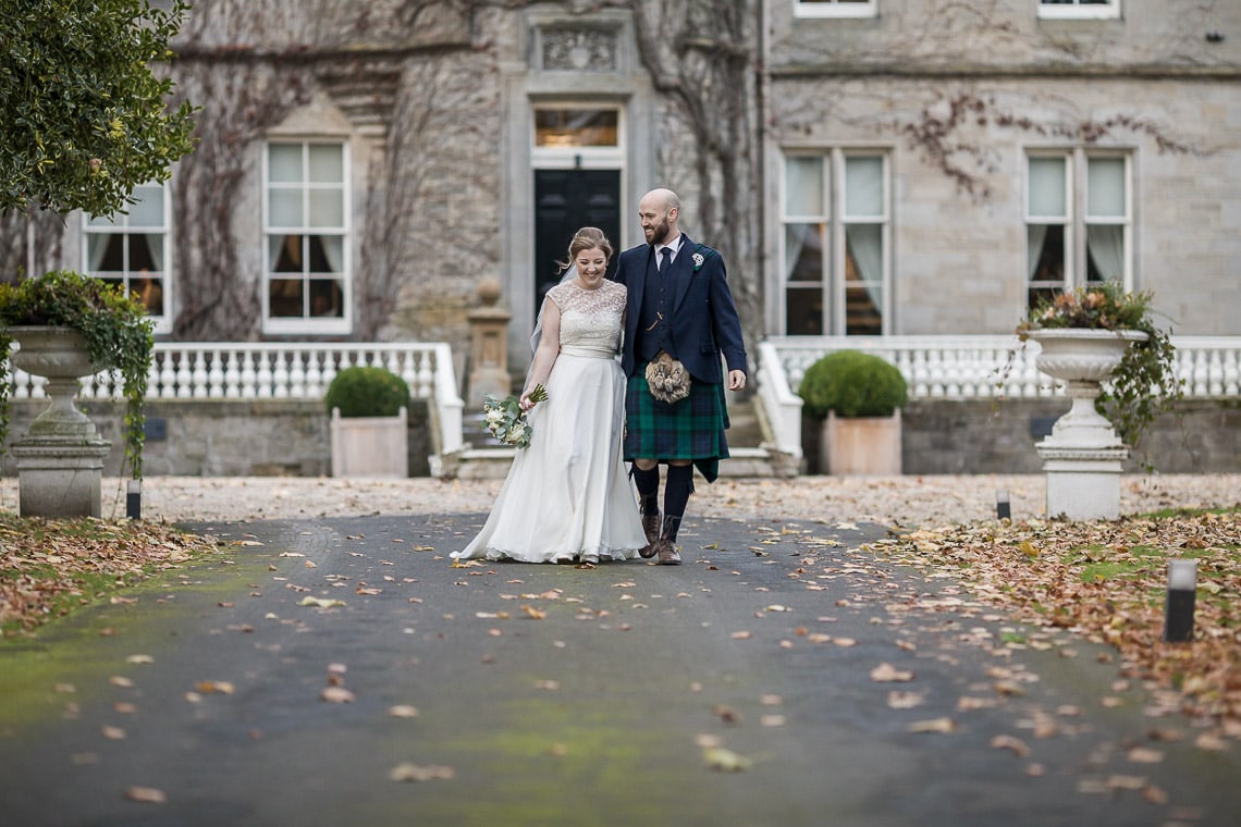 newlyweds walking down the driveway