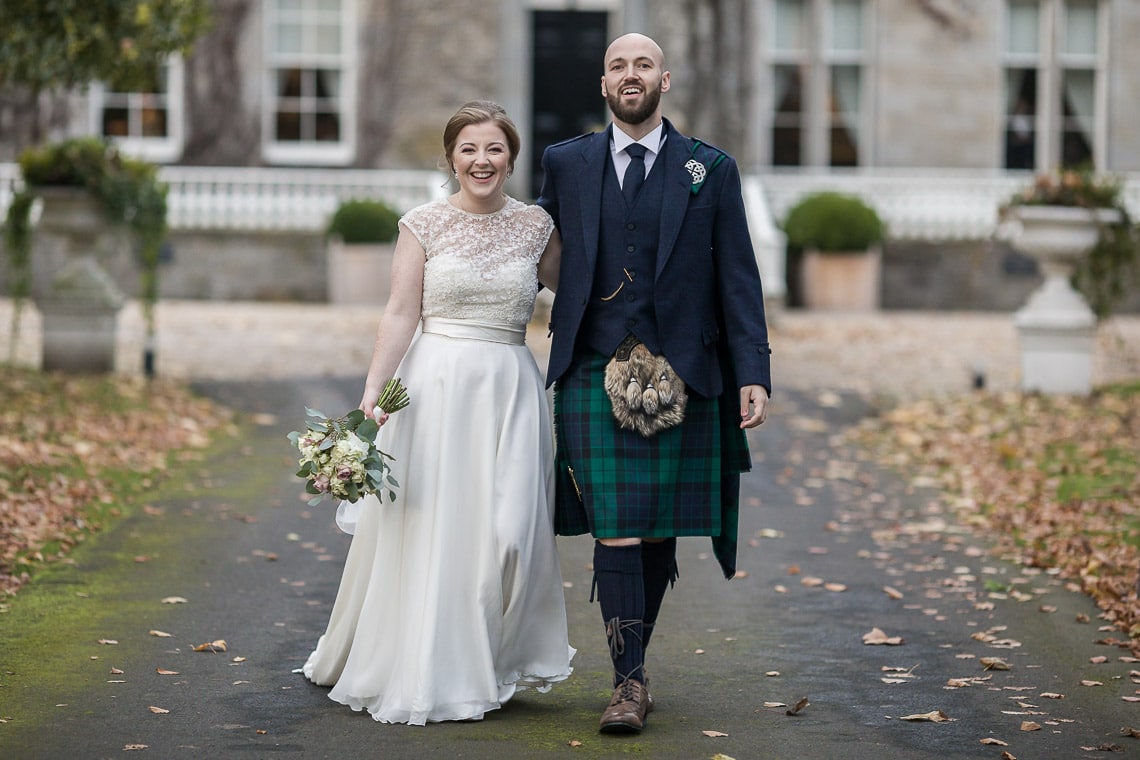 newlyweds walking down the driveway