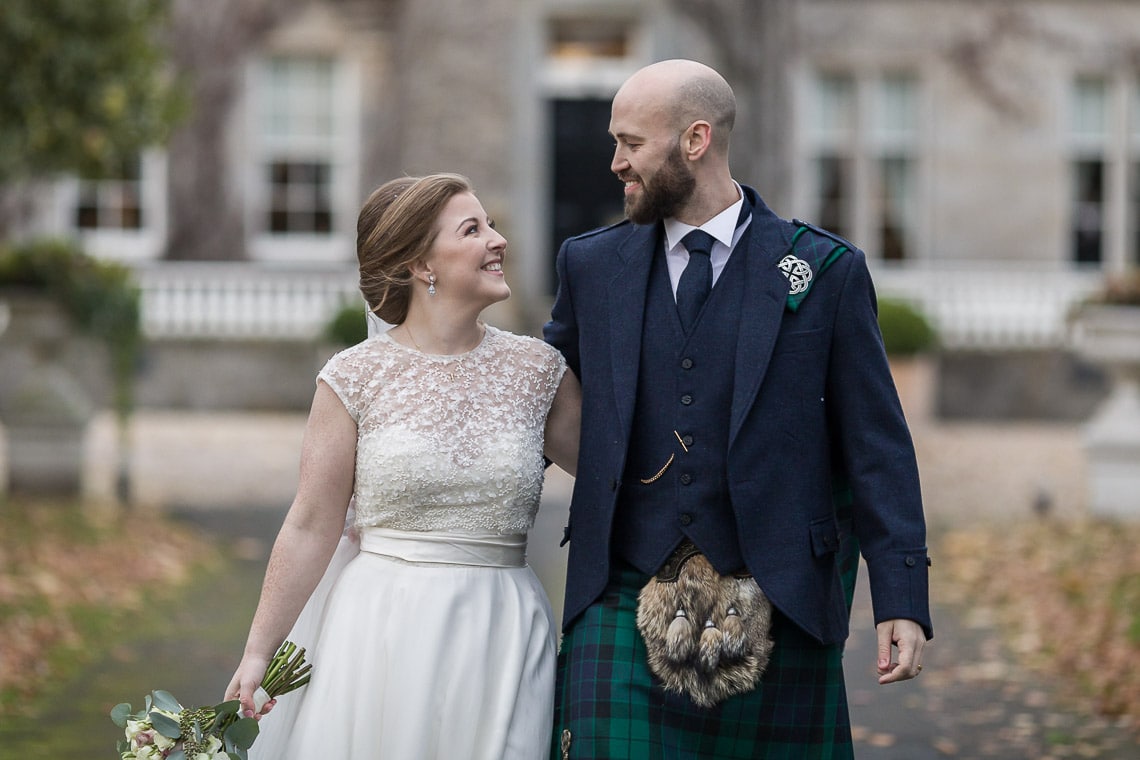 newlyweds walking down the driveway