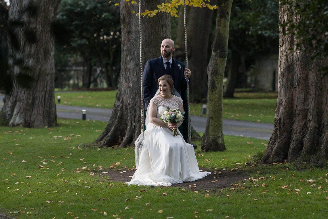 newlyweds on the wooden swing
