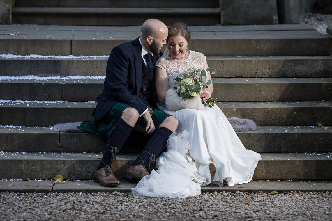 newlyweds sitting on the steps