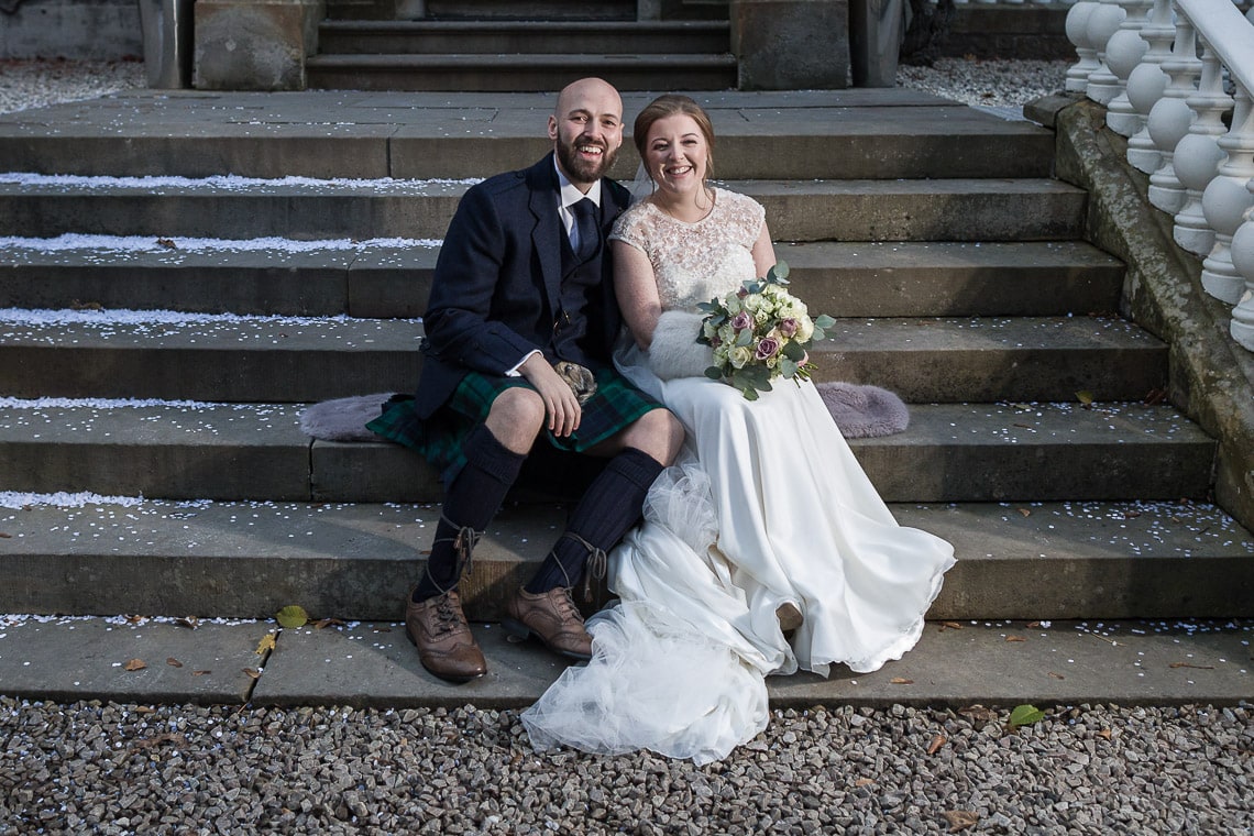 newlyweds sitting on the steps