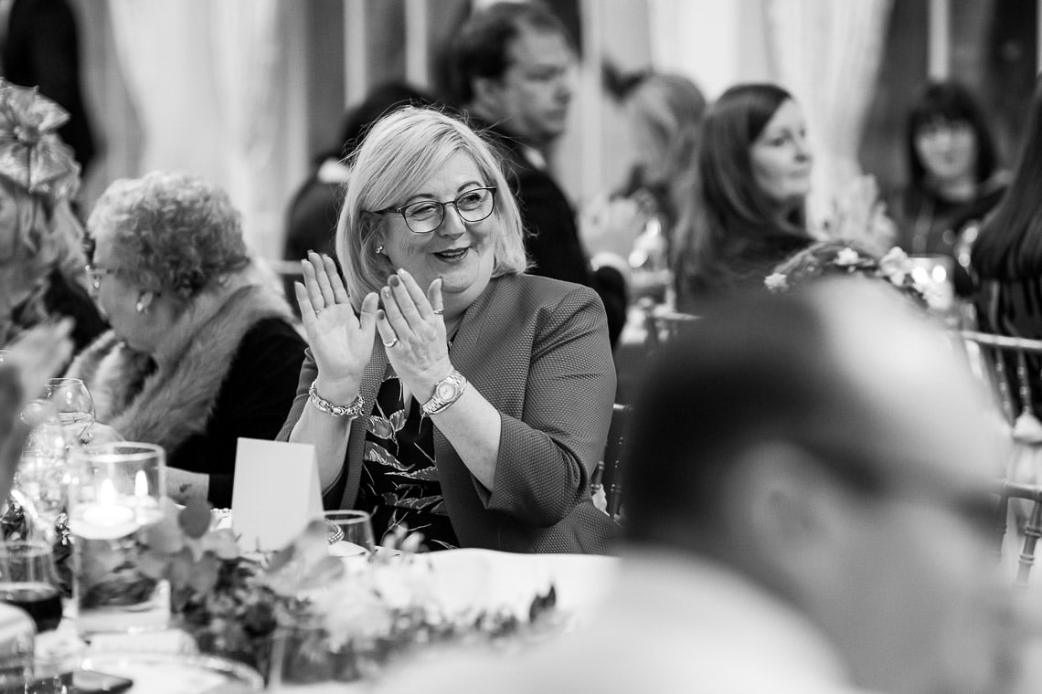 female guest clapping the newlywed entrance to the wedding breakfast