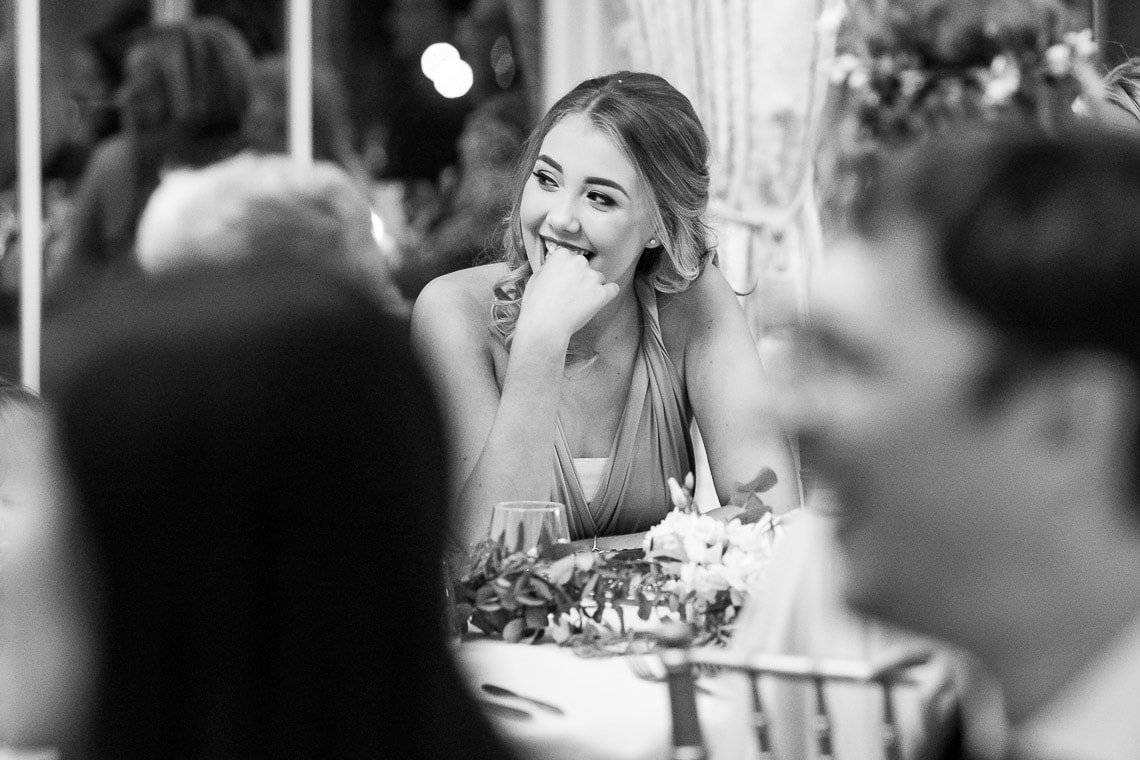 bridesmaid smiling at father of the bride speech
