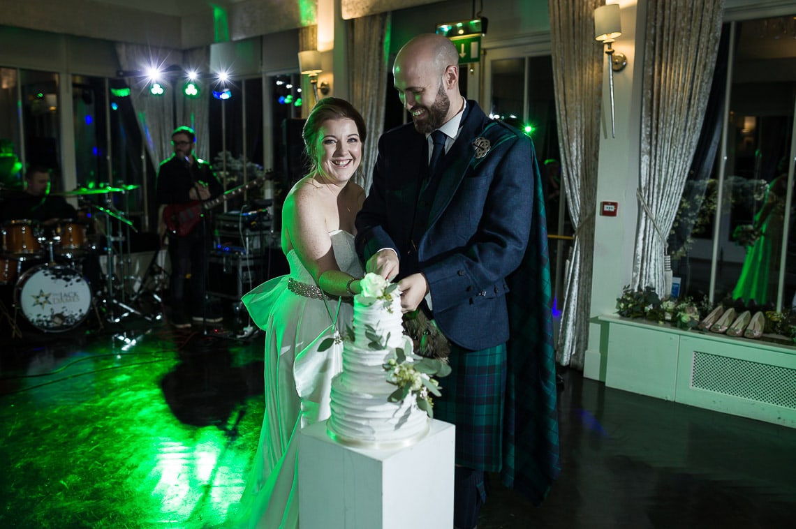 newlyweds cutting the cake