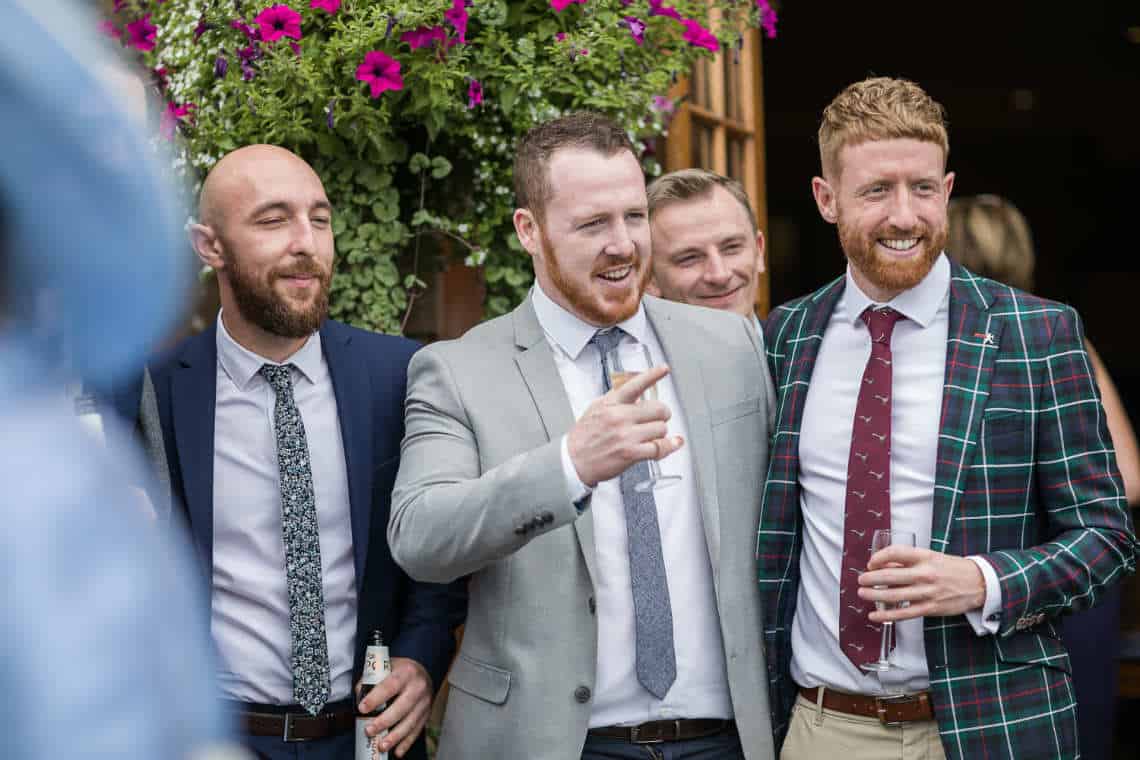 Guests smiling at outdoor drinks reception