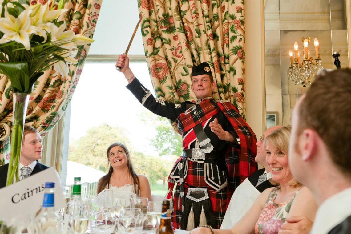 Croquet Room piper addresses the haggis with dirk drawn