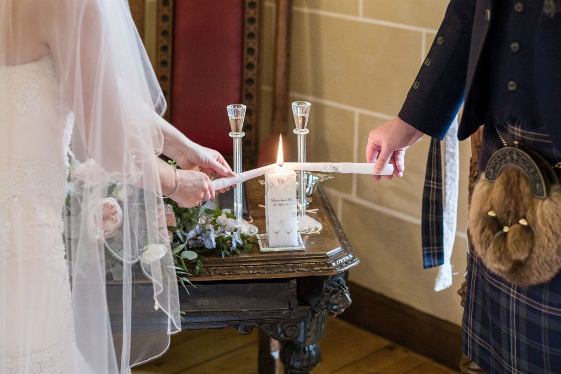 Bride and Groom lighting a unity candle.
