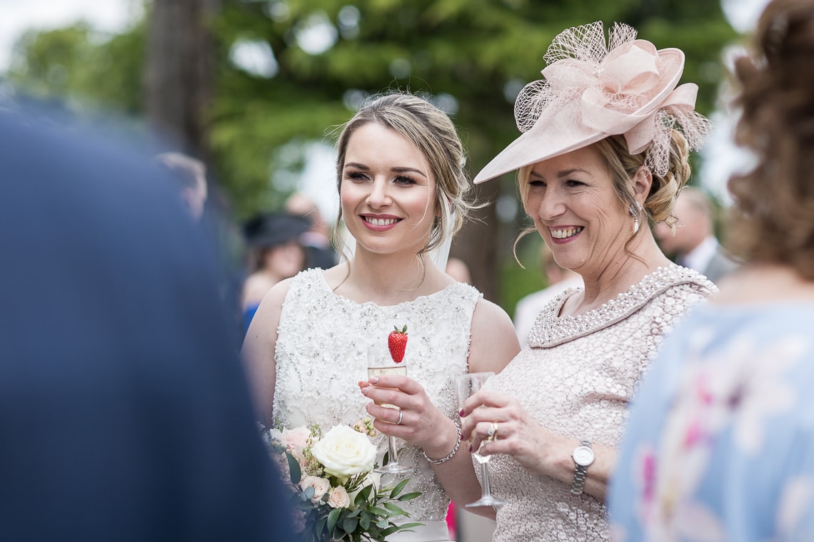 bride and mother chatting to guests