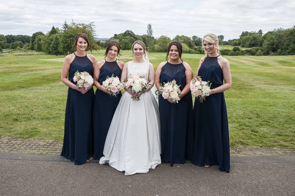 bridesmaids group photo in front of the golf course