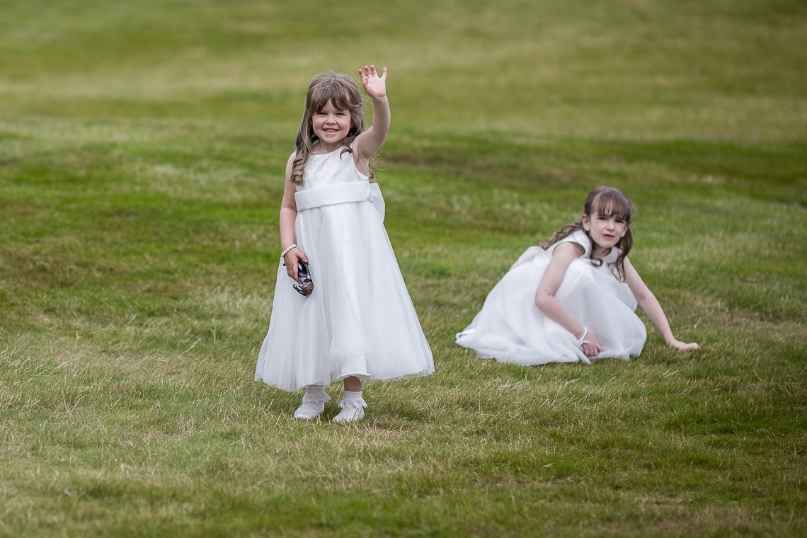 flower girl waving for the camera