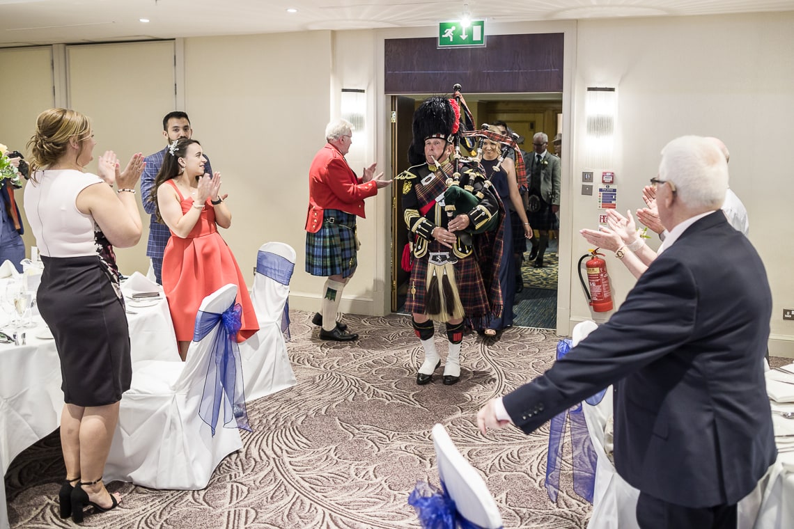 Piper leads guests to the top table