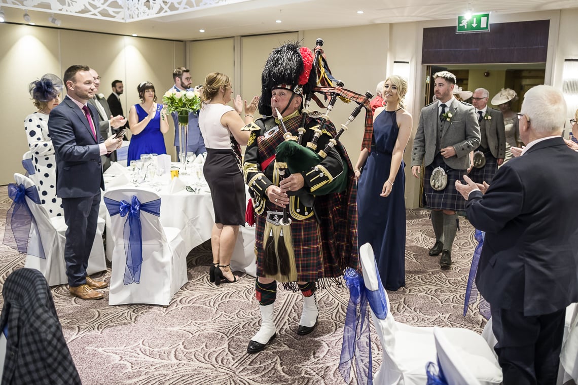 Piper leads guests to the top table