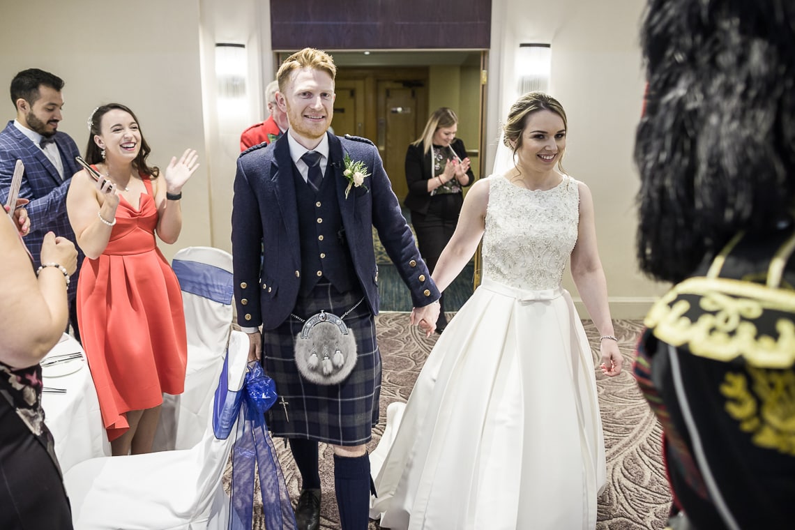 newlyweds making their way to the top table