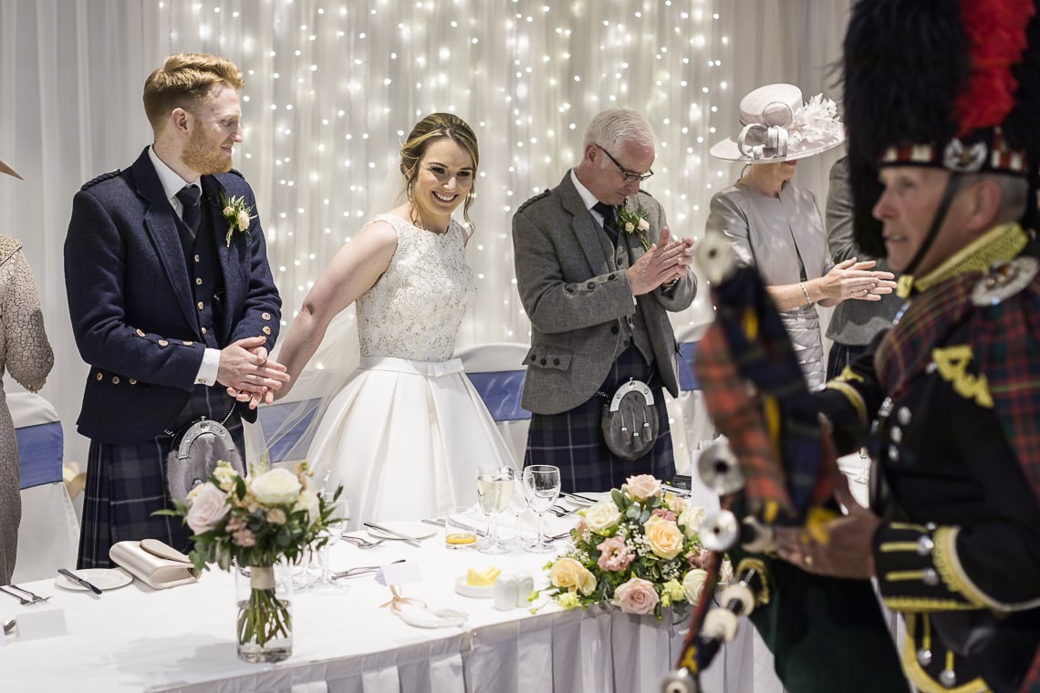 newlyweds making their way to the top table