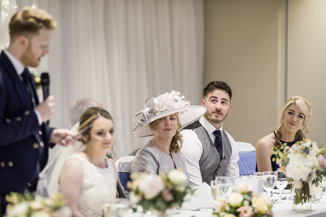mother of the bride listening to the groom speech