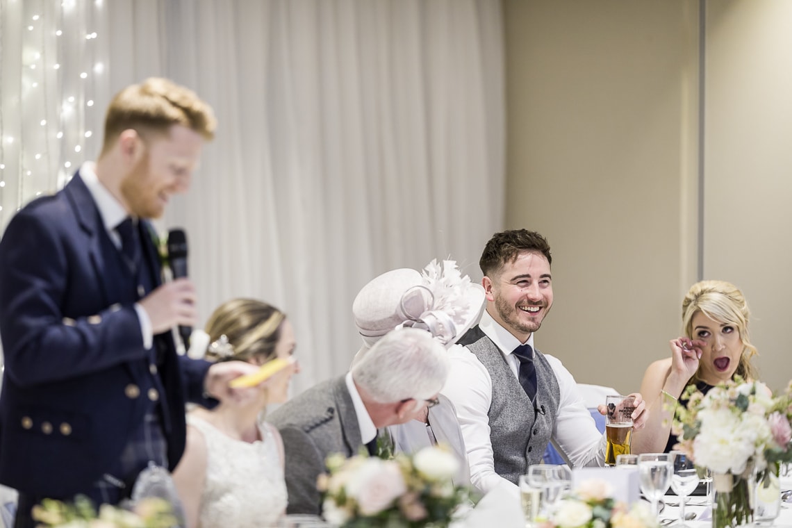 best man laughing during the groom speech
