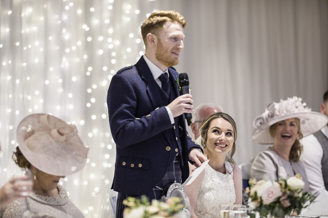 bride laughing during the groom speech