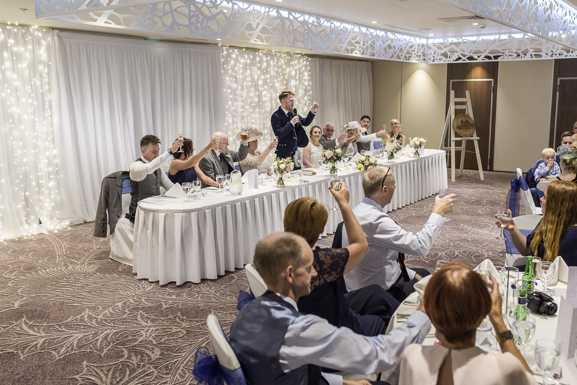 groom raises a toast during his speech