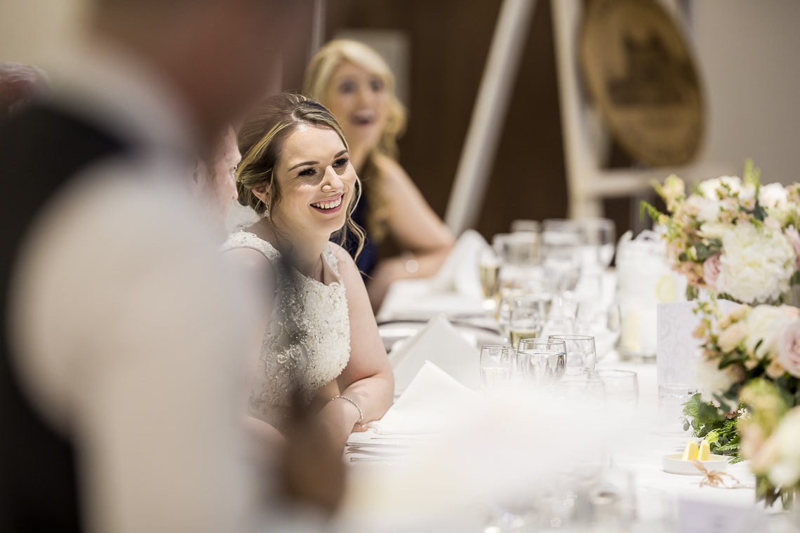 bride laughs during best men speech